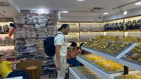 A visitor exploring a jewelry wholesale market in Shuibei