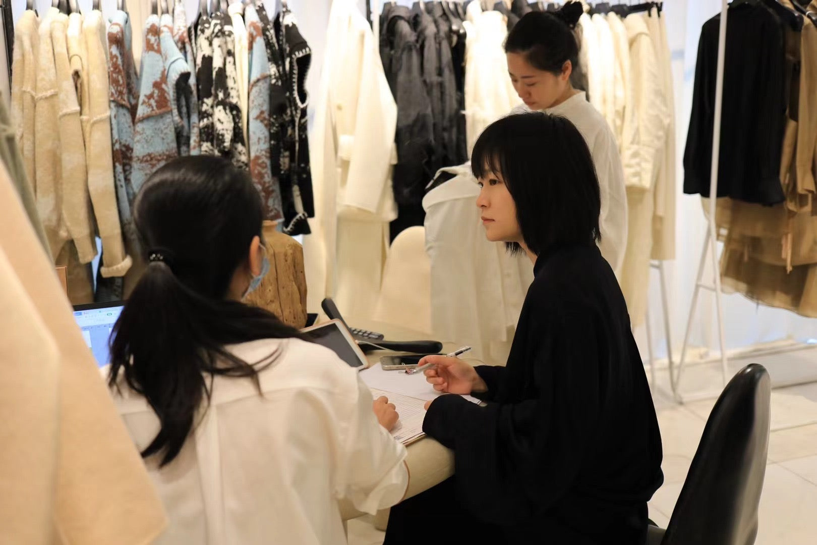 A fashion team discussing products inside a Shenzhen showroom