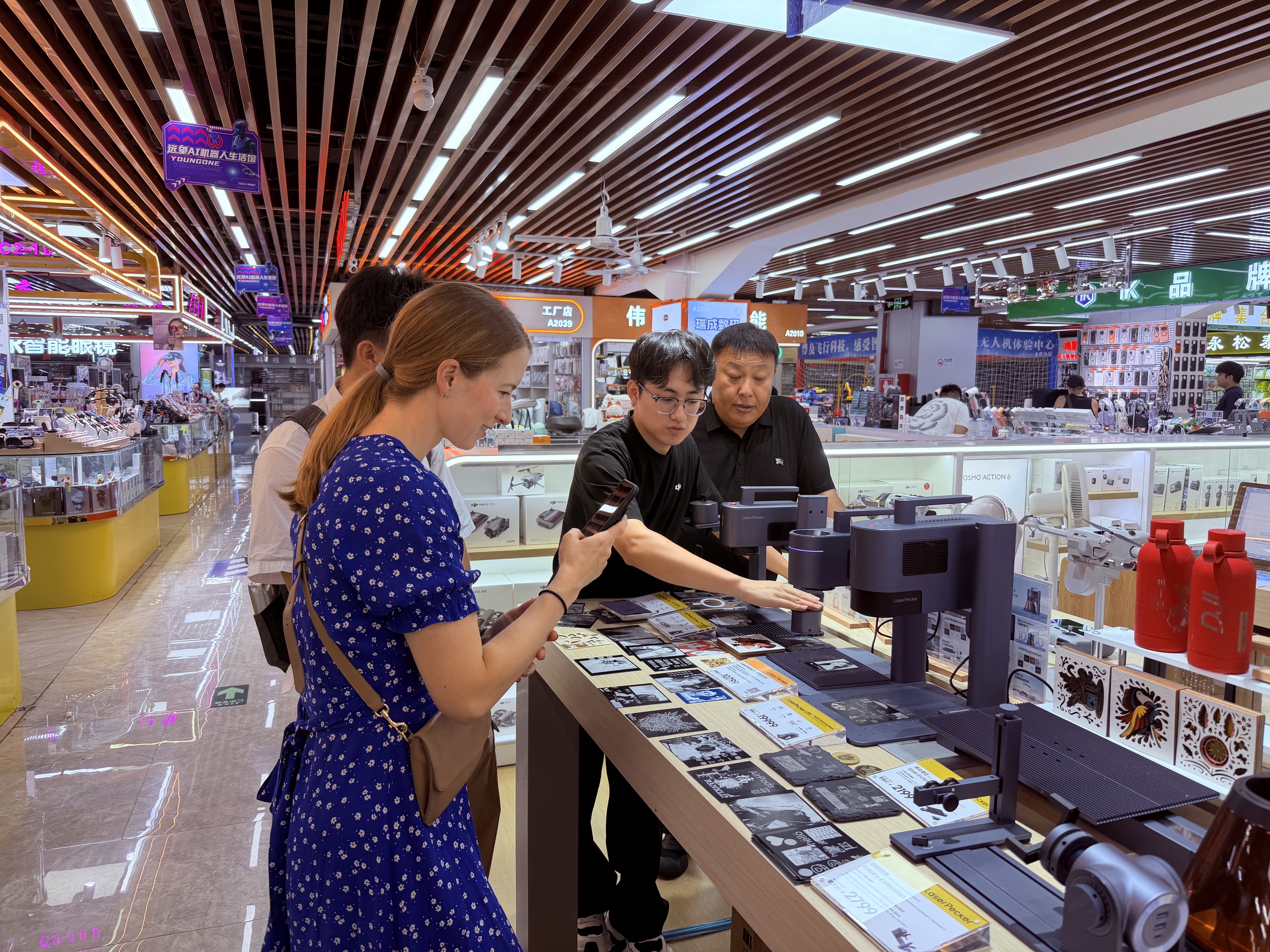 A visitor examining hardware products inside Huaqiangbei electronics market
