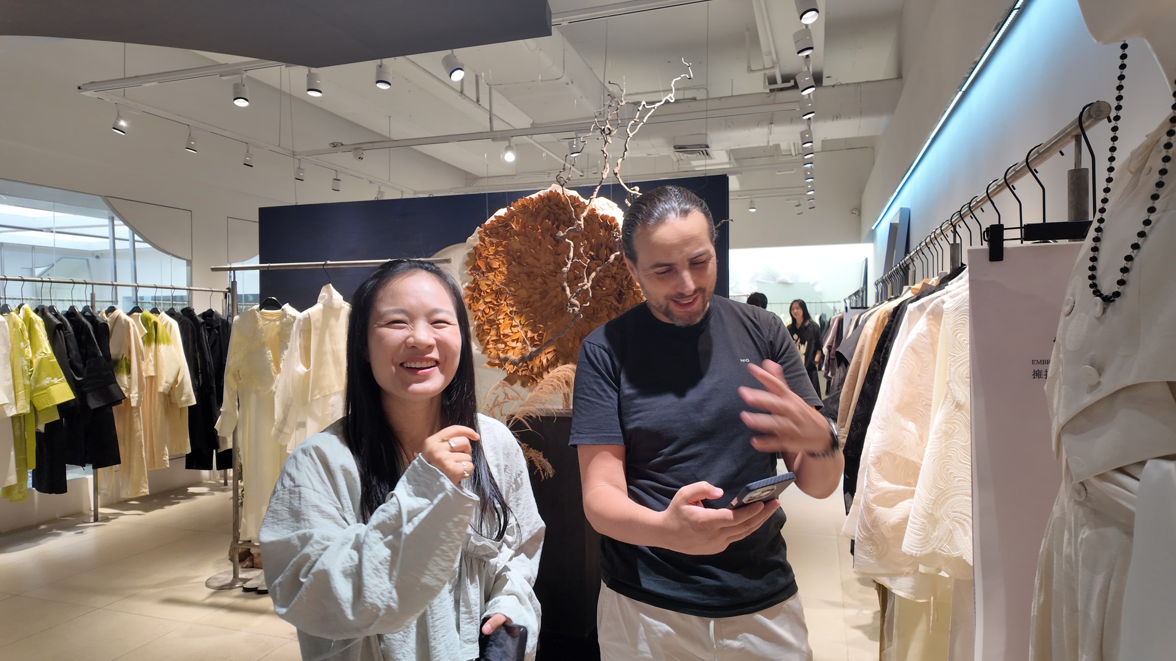 A visitor discussing fashion products inside a Shenzhen showroom